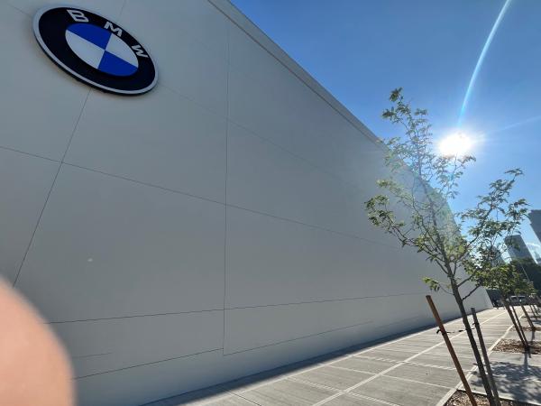 The uninterrupted white wall of the BMW dealership on 43rd Ave.